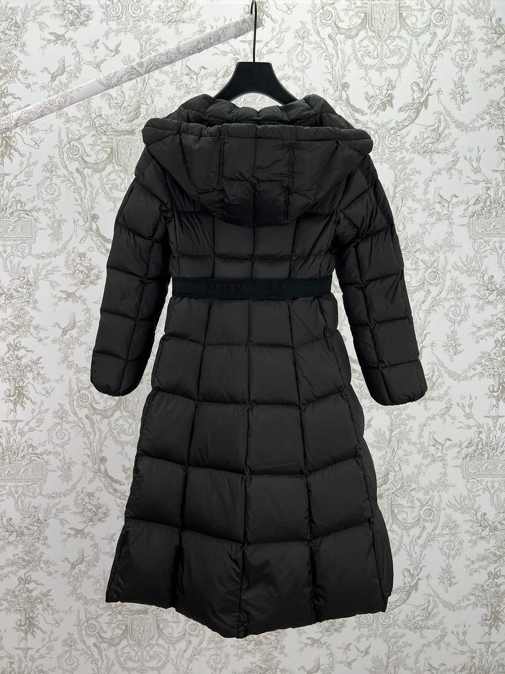 Black long puffer coat with hood and zip back view