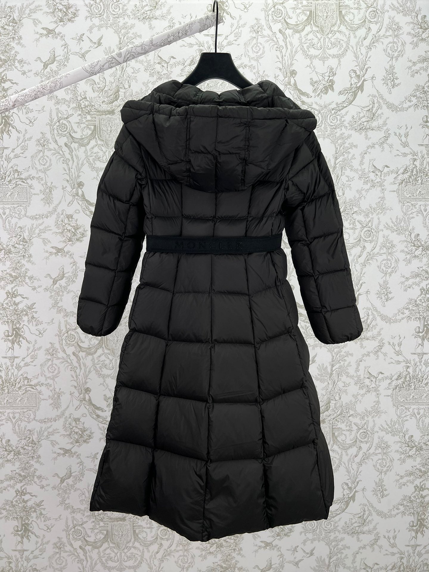 Black long puffer coat with hood and zip back view