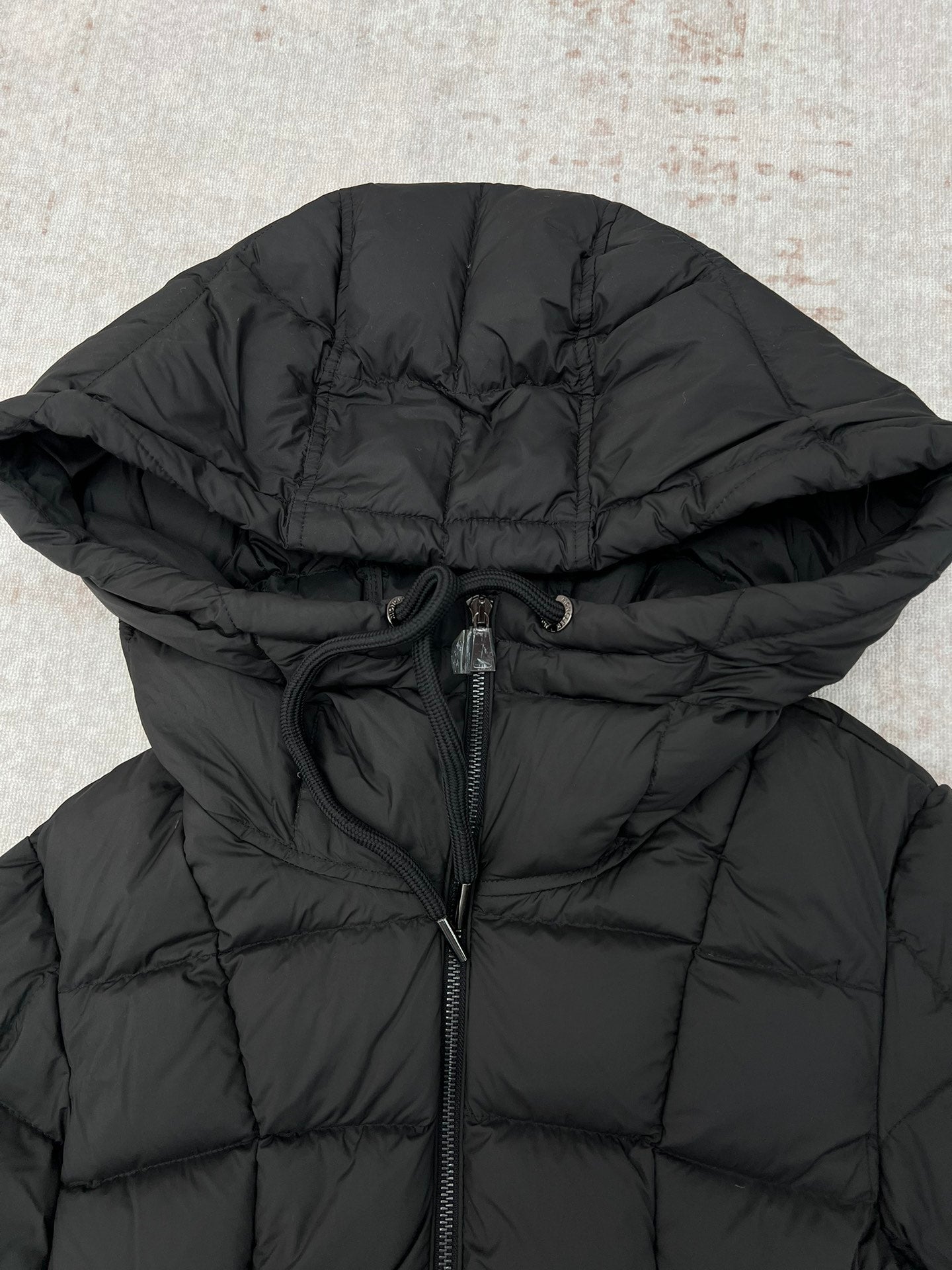 Dark puffer coat hood with adjustable drawcord and front zipper