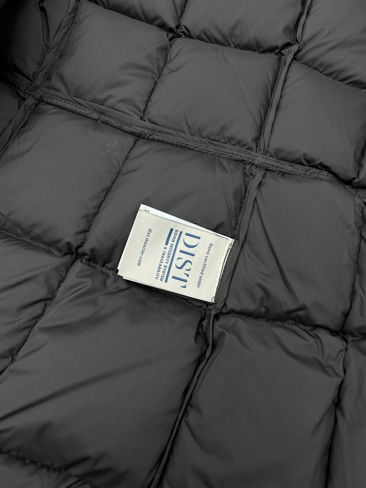 Care label on black puffer coat inner panel