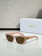 Dior sunglasses, pink frame with dark lenses and gold logo hinge