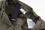 Olive drawstring pants with Stone Island branded labels and elastic waist