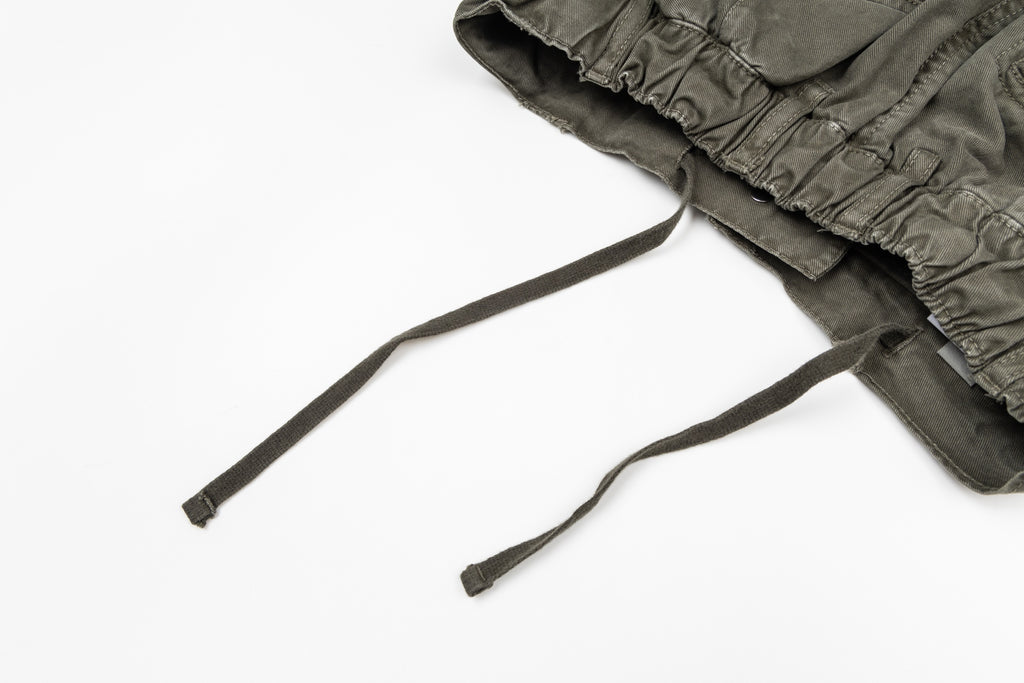 Olive drawstring pants with elastic waistband and two cords