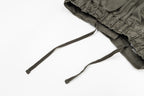 Olive drawstring pants with elastic waistband and two cords