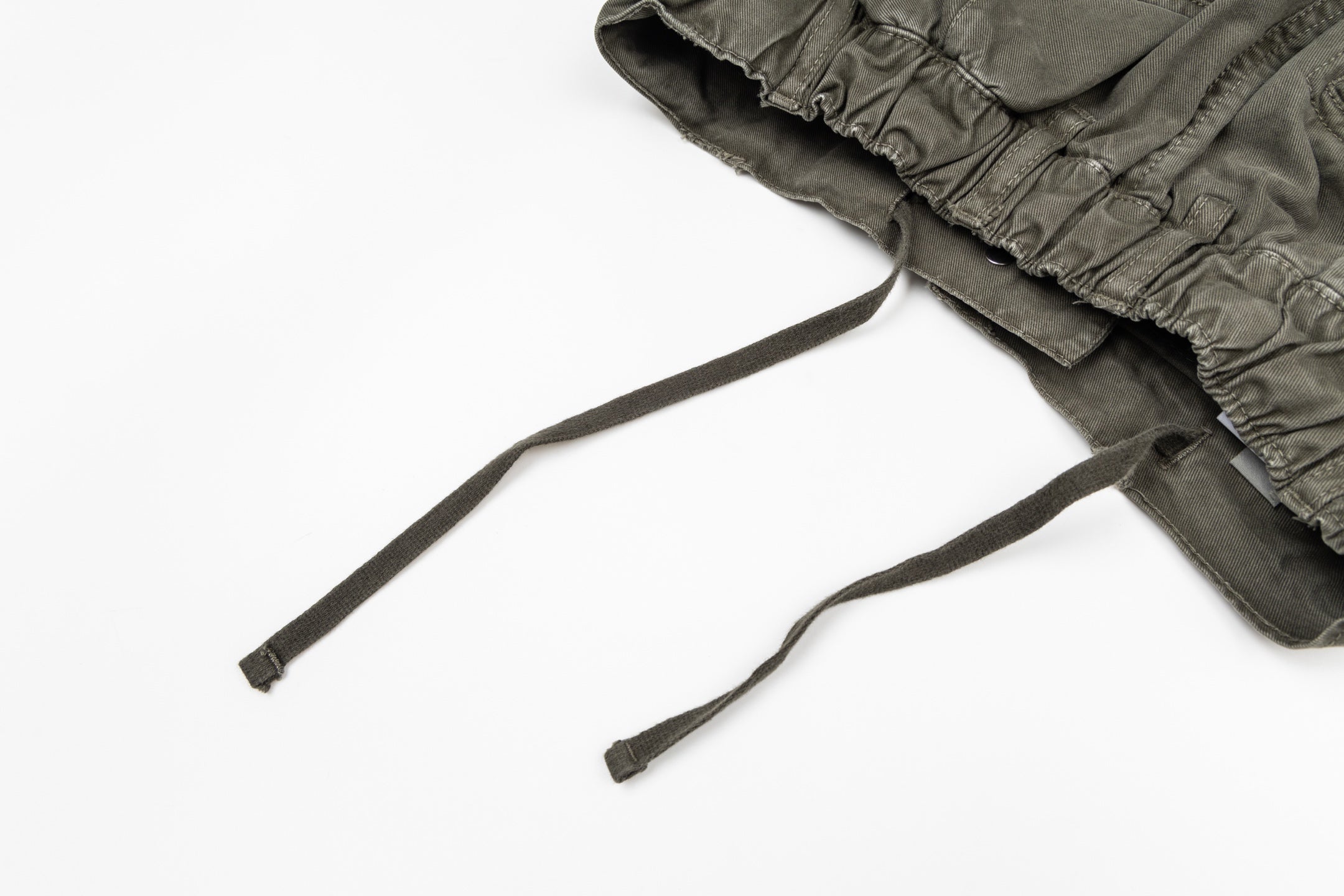 Olive drawstring pants with elastic waistband and two cords