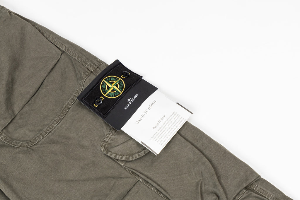Stone Island olive cargo pants with black label patch on a front pocket