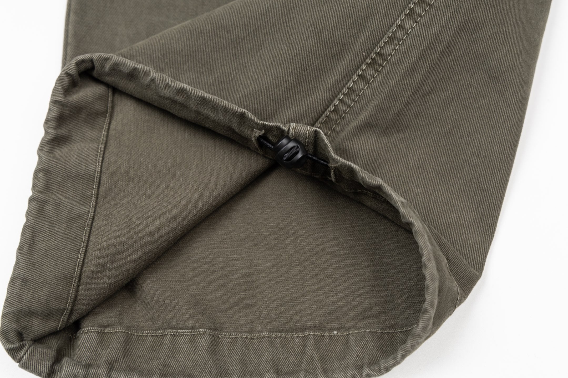 Stone Island olive cargo pants close-up of inner drawcord and pocket seam