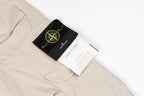 Stone Island cargo pants with black brand patch and white care label on pocket