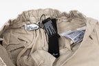 Stone Island beige cargo pants with elastic waist and care labels inside