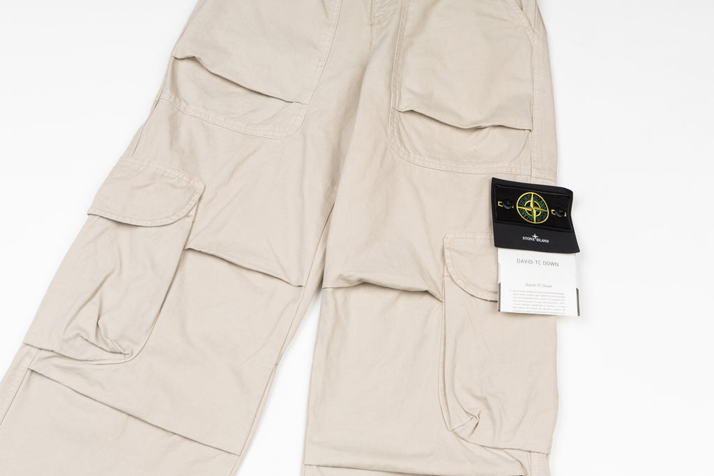 Stone Island beige cargo pants detail with flap pockets and hanging size tag