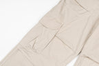 Stone Island beige cargo pants with stitched pocket panels and seams