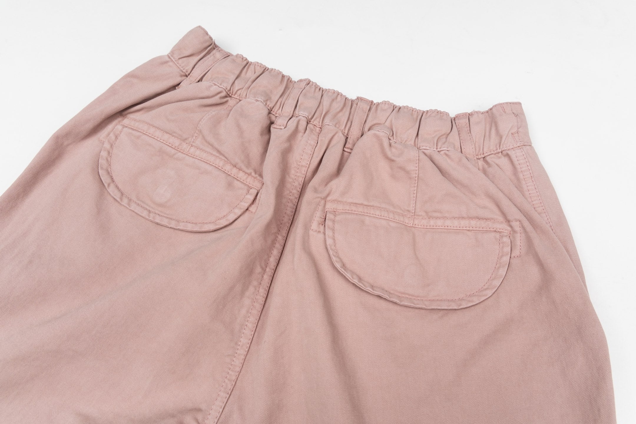 Stone Island pants in dusty pink with elastic waistband and front patch pockets