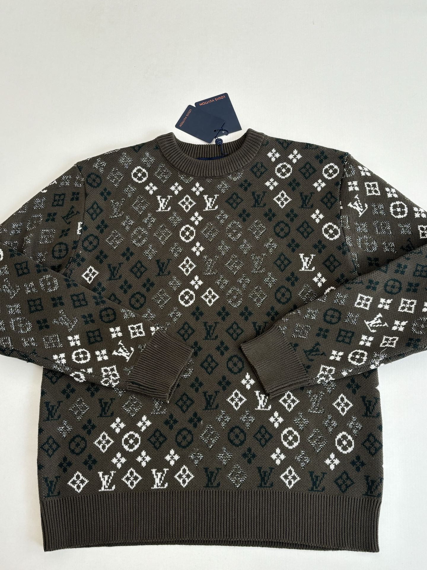 Crewneck knit sweater with dark allover logo-style pattern and ribbed neckline