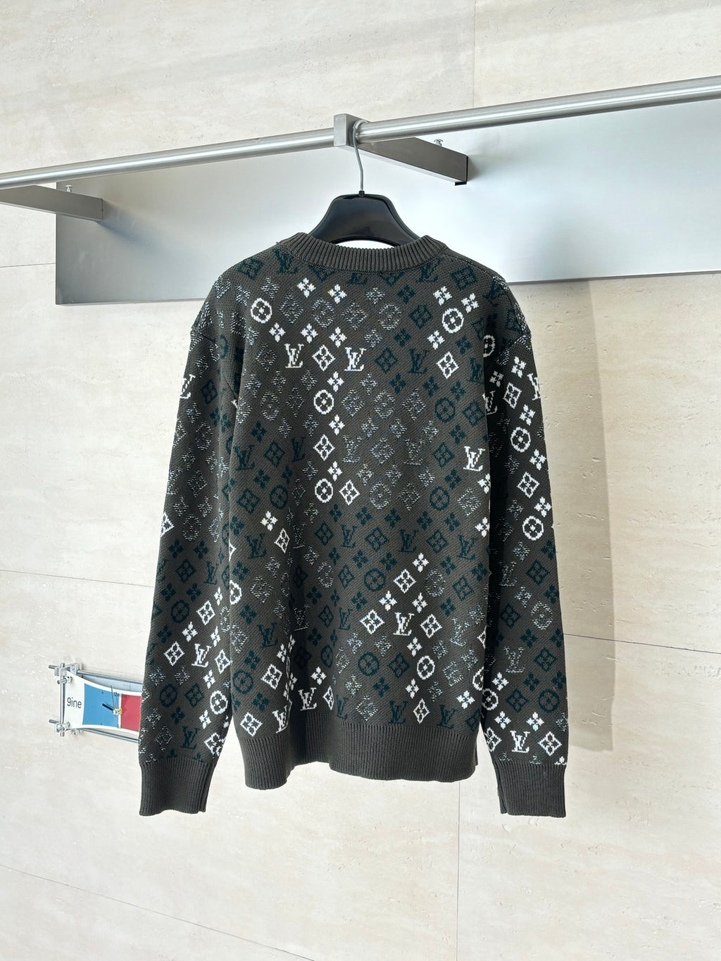 Crewneck knit sweater in dark tone with allover pattern, ribbed cuffs