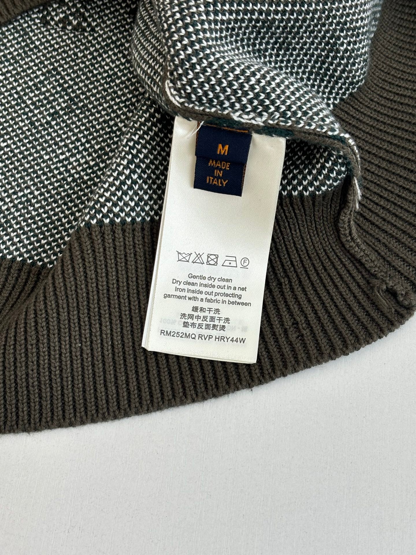 Size tag on knit sweater with ribbed collar; marked made in Italy