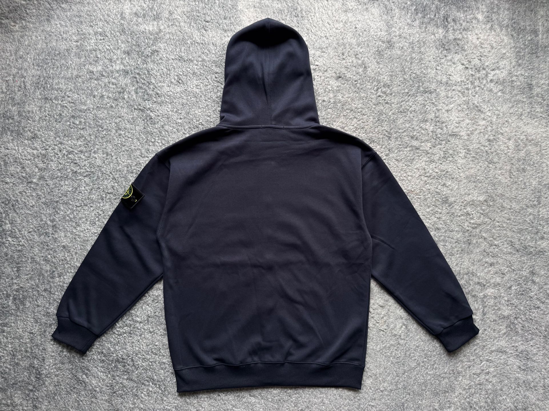 Navy zip-up hoodie with hood and drawstrings, back view