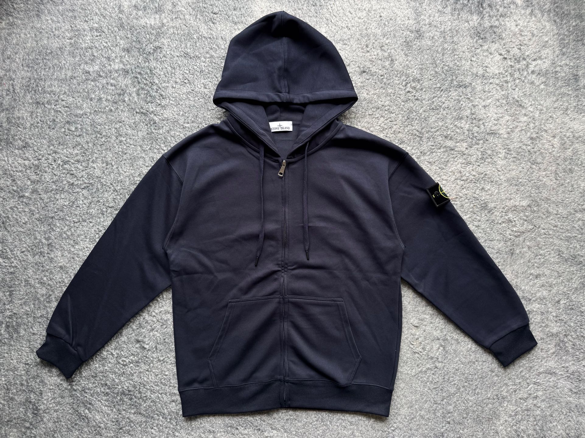 Navy zip-up hoodie with hood, drawstrings, and front kangaroo pocket