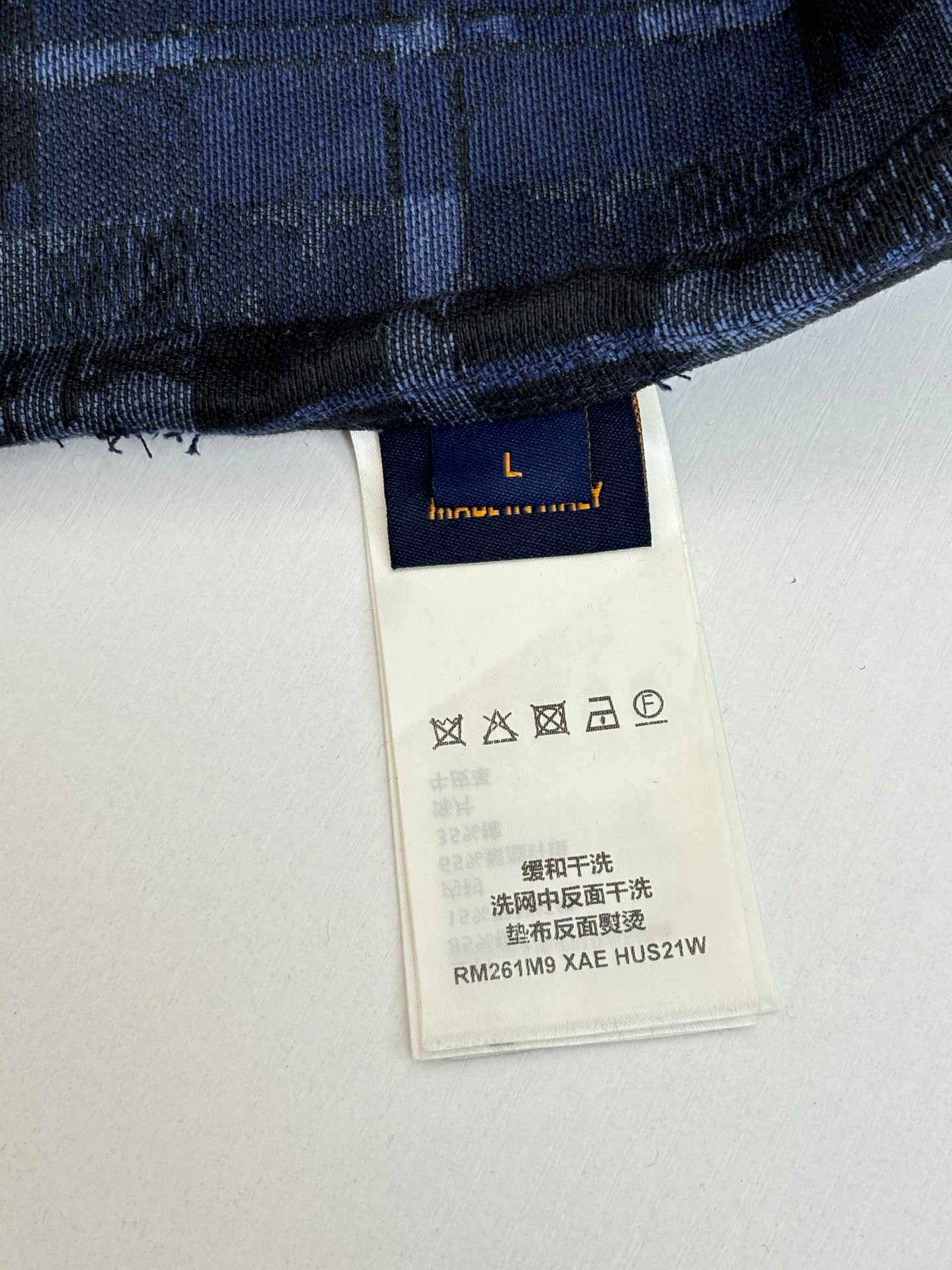 Louis Vuitton long-sleeve shirt care label with washing symbols and style code