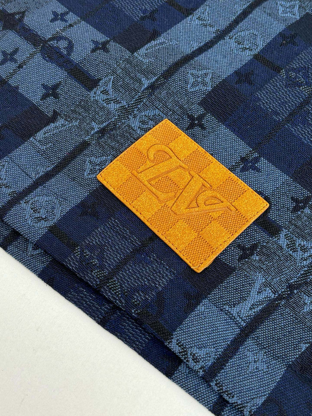 Close-up of Louis Vuitton long-sleeve shirt fabric, blue check monogram and orange patch