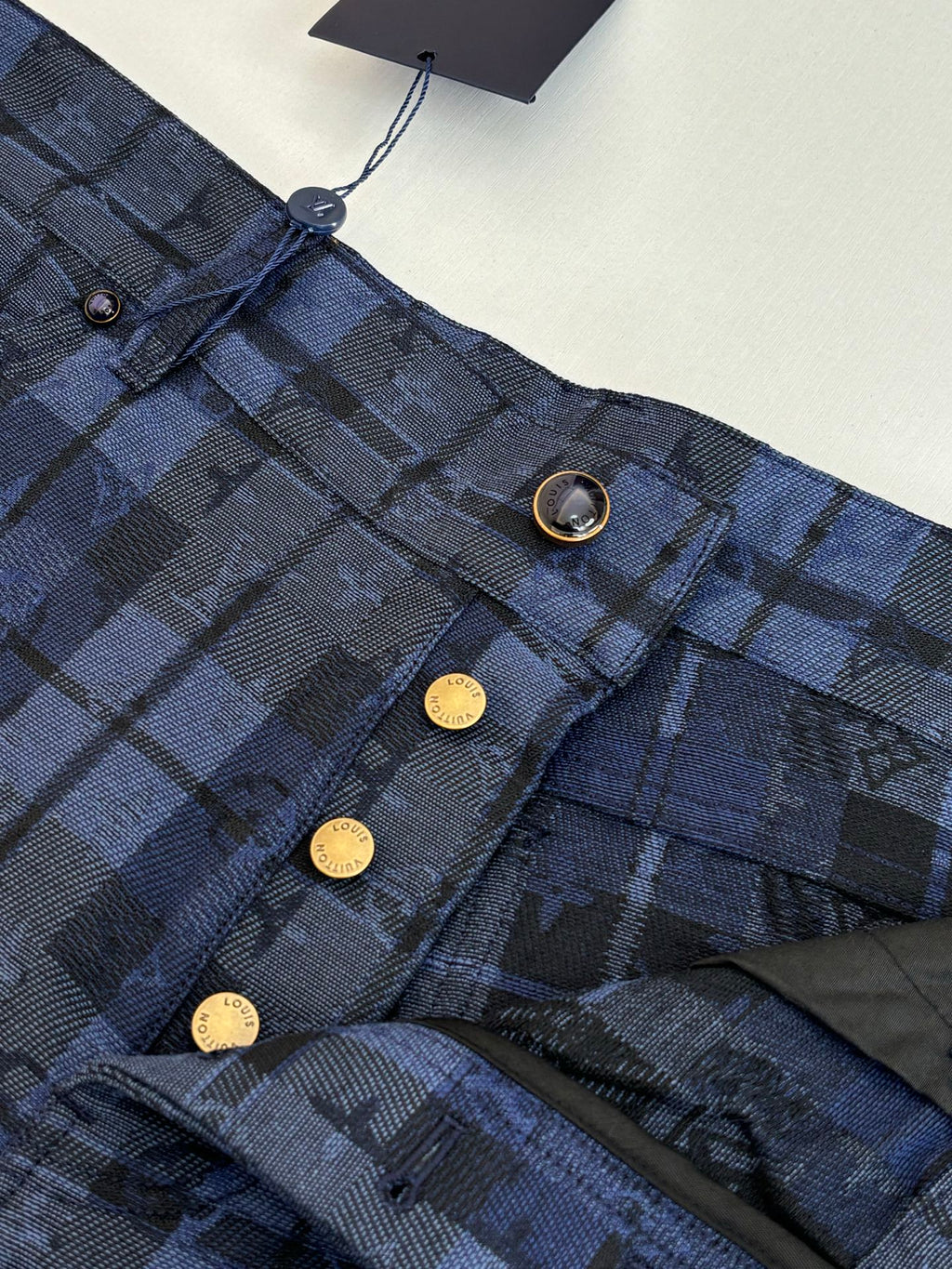 Checked trousers waistband detail, metal buttons and belt loops
