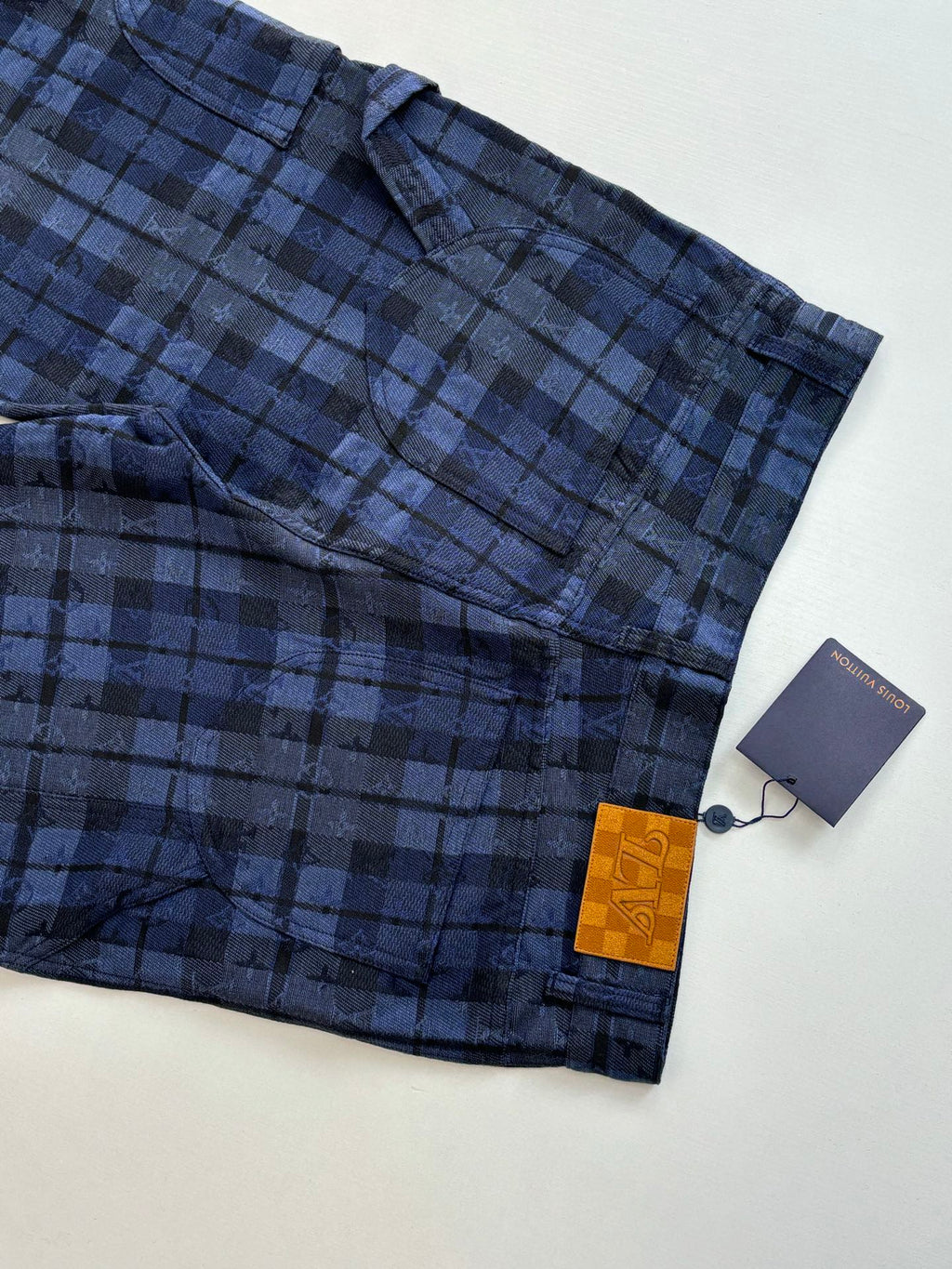 Plaid trousers hem and pocket area in dark blue check with hang tag