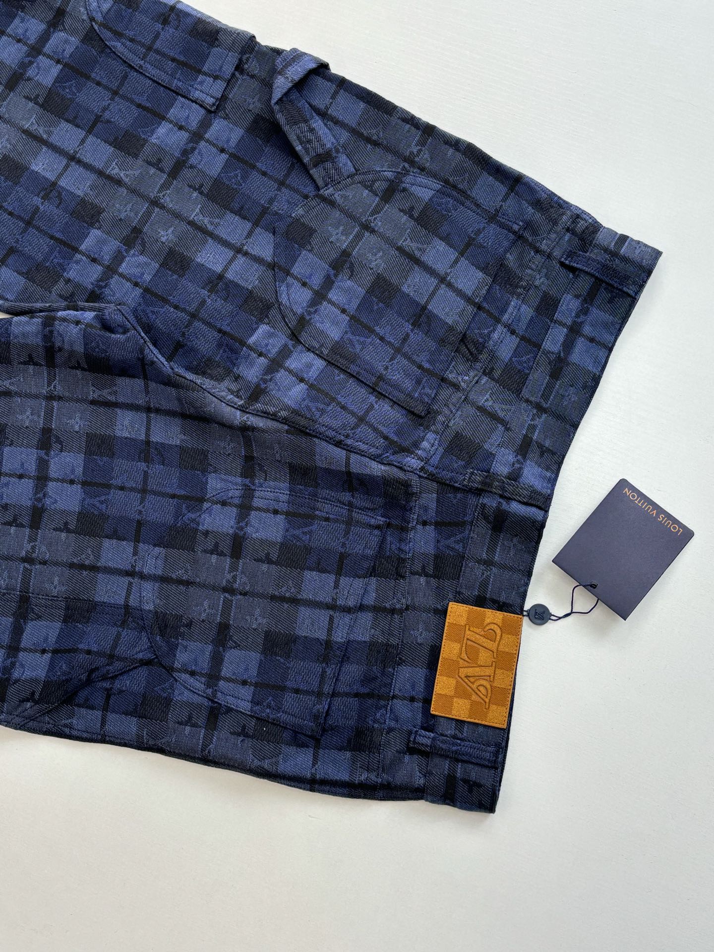 Plaid trousers hem and pocket area in dark blue check with hang tag