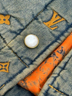 Louis Vuitton denim jacket button detail with yellow monogram trim and orange stitching