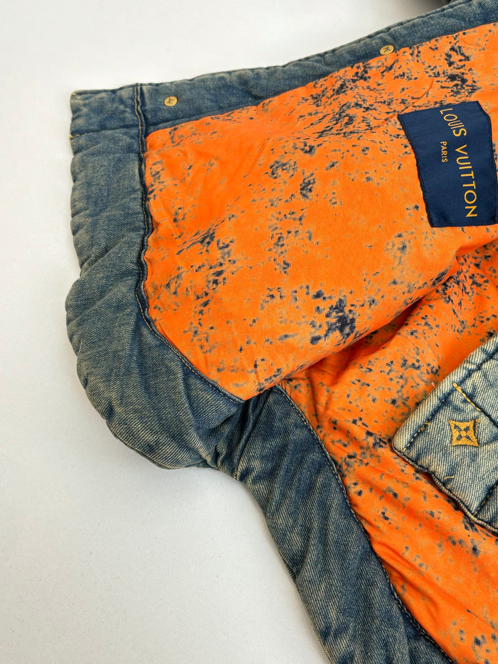 Louis Vuitton jacket interior with orange lining panel and Louis Vuitton logo label