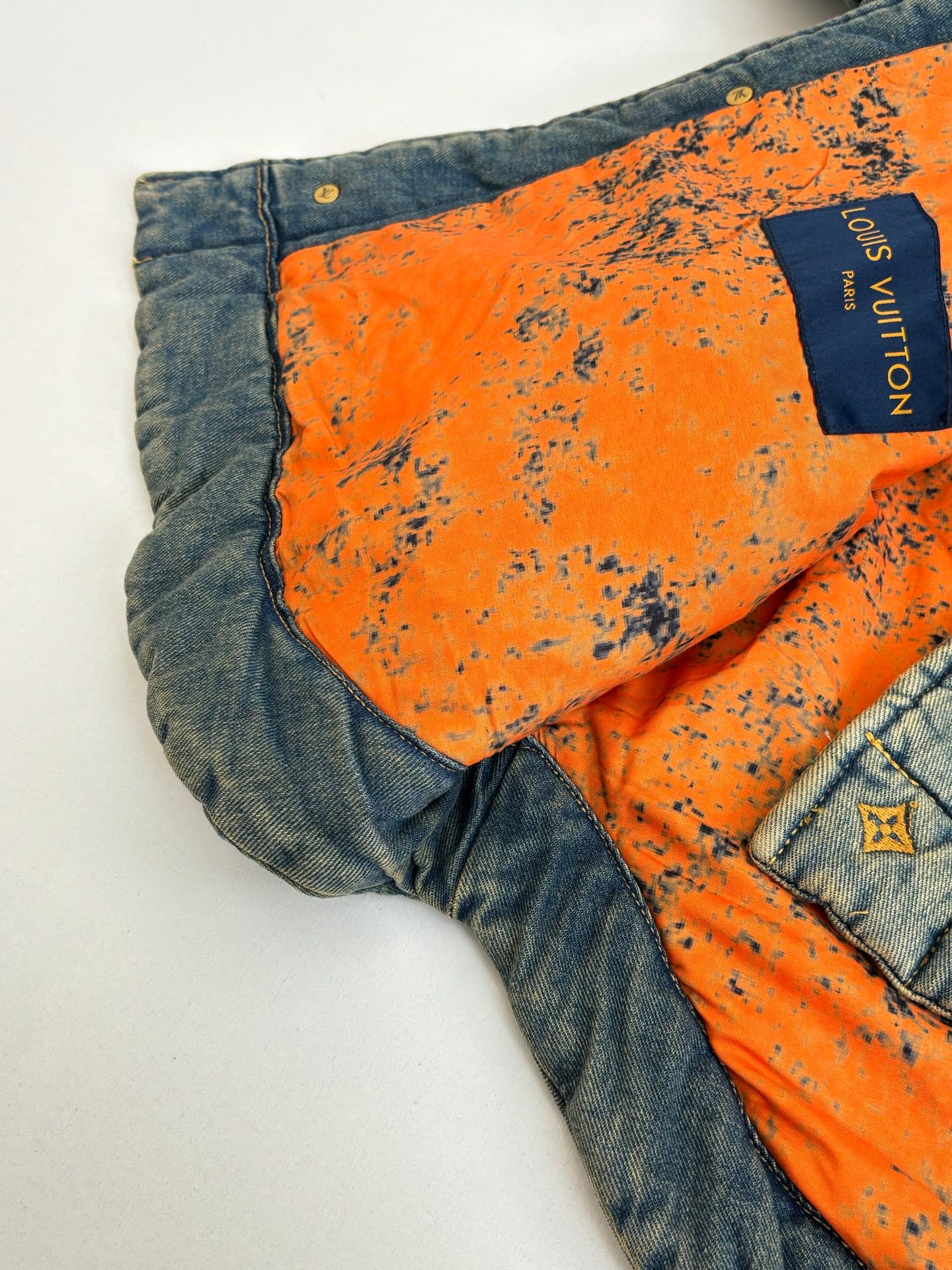 Louis Vuitton jacket interior with orange lining panel and Louis Vuitton logo label