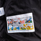 Long black puffer jacket, colorful care instructions label on front