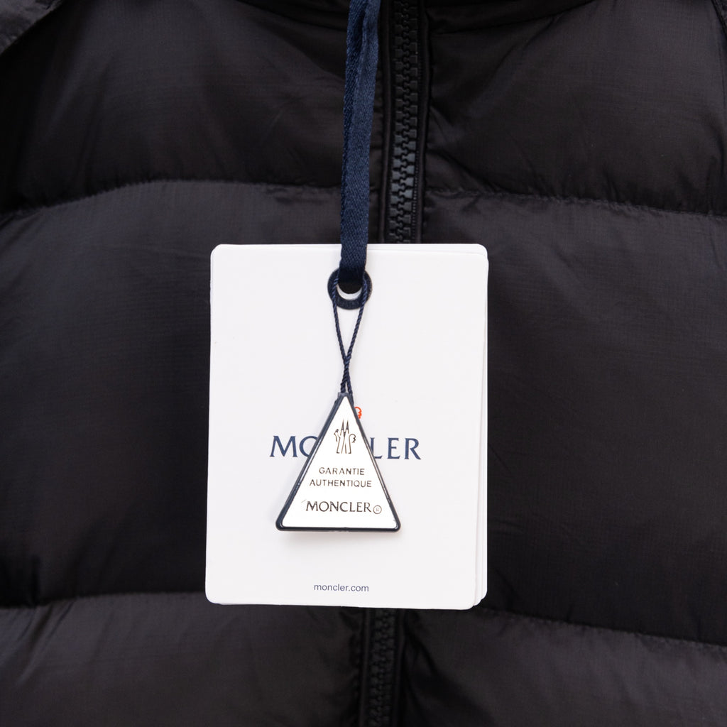 Moncler authenticity hang tag on black puffer jacket