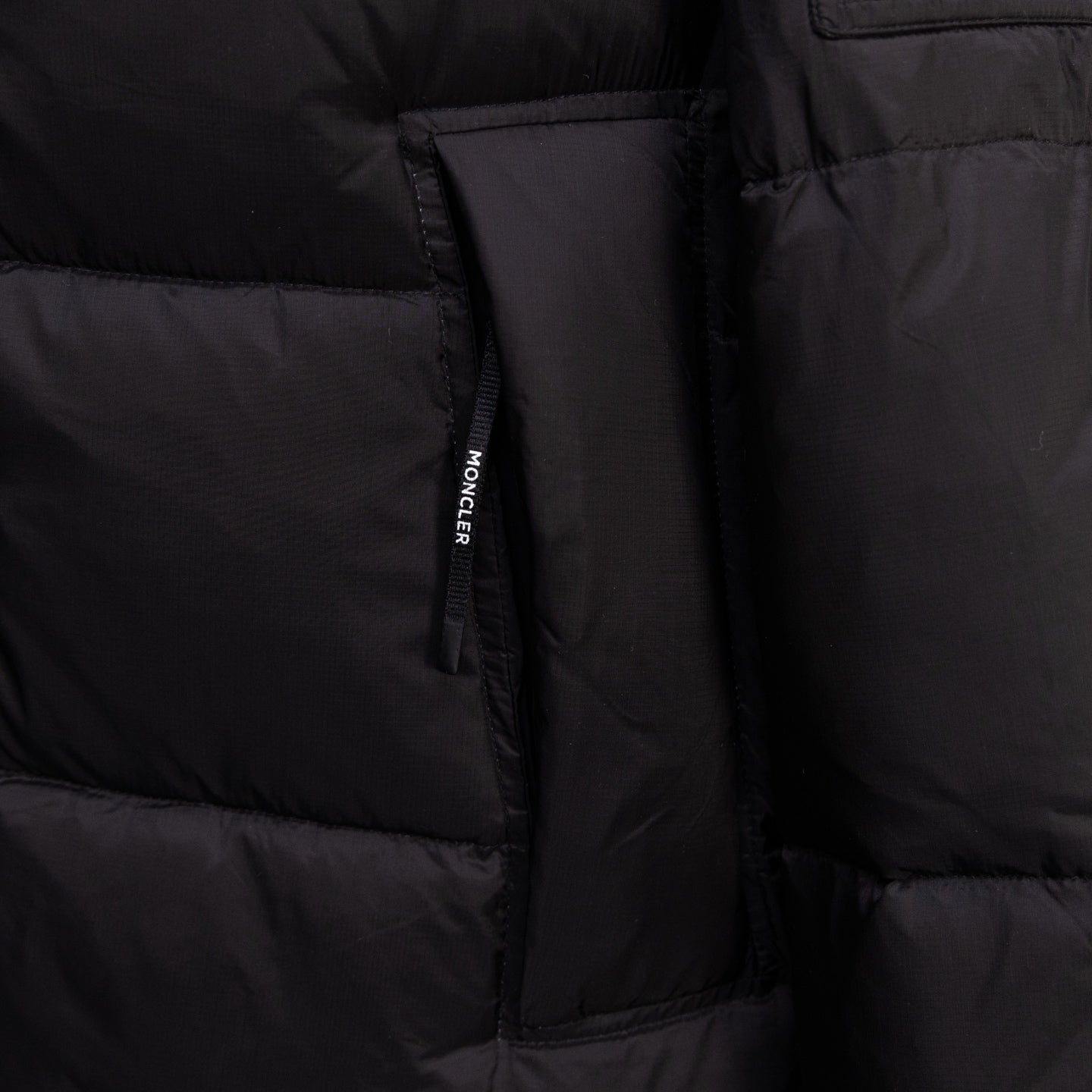 Long black puffer jacket, inner label at side seam