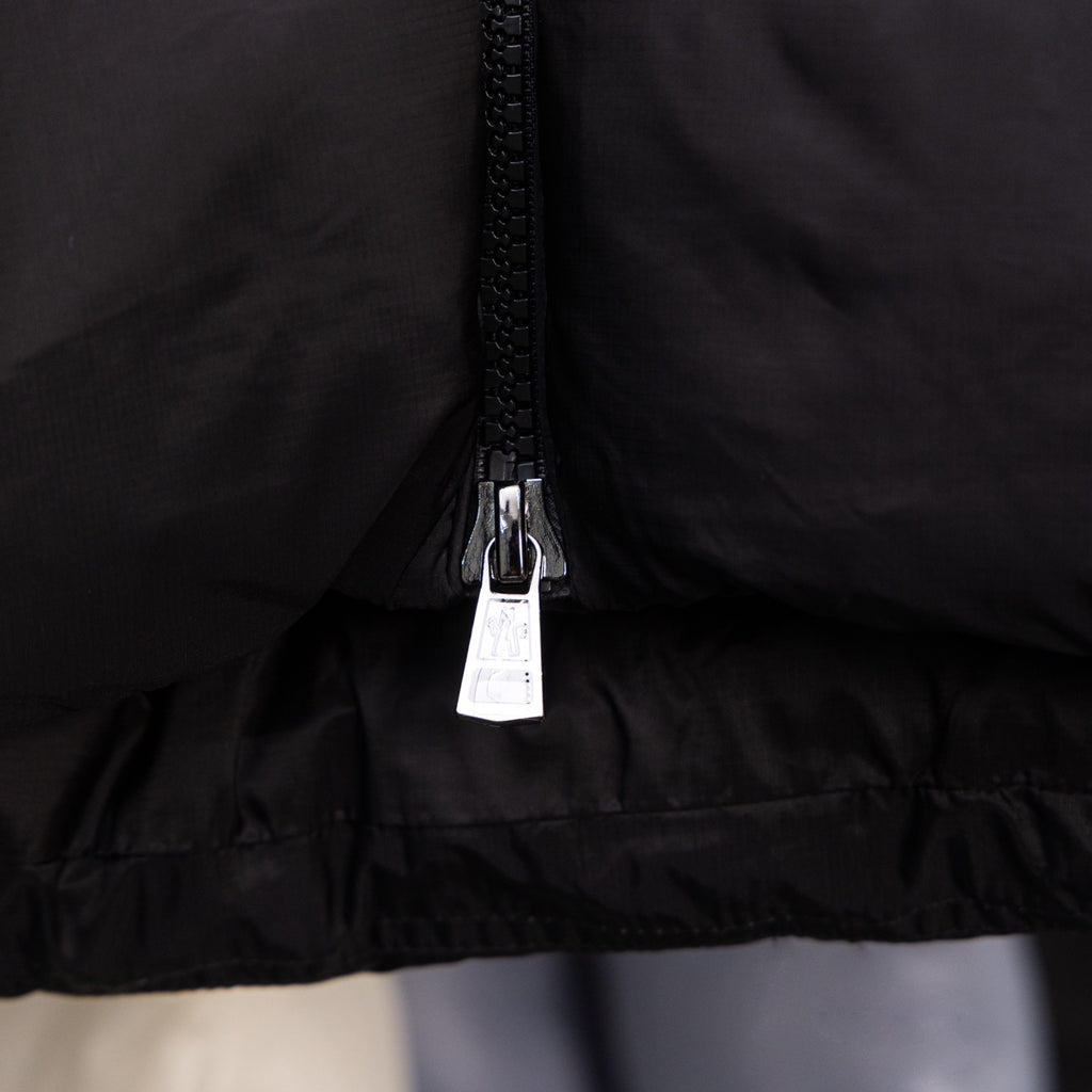 Long black puffer jacket, centered front zipper and hem
