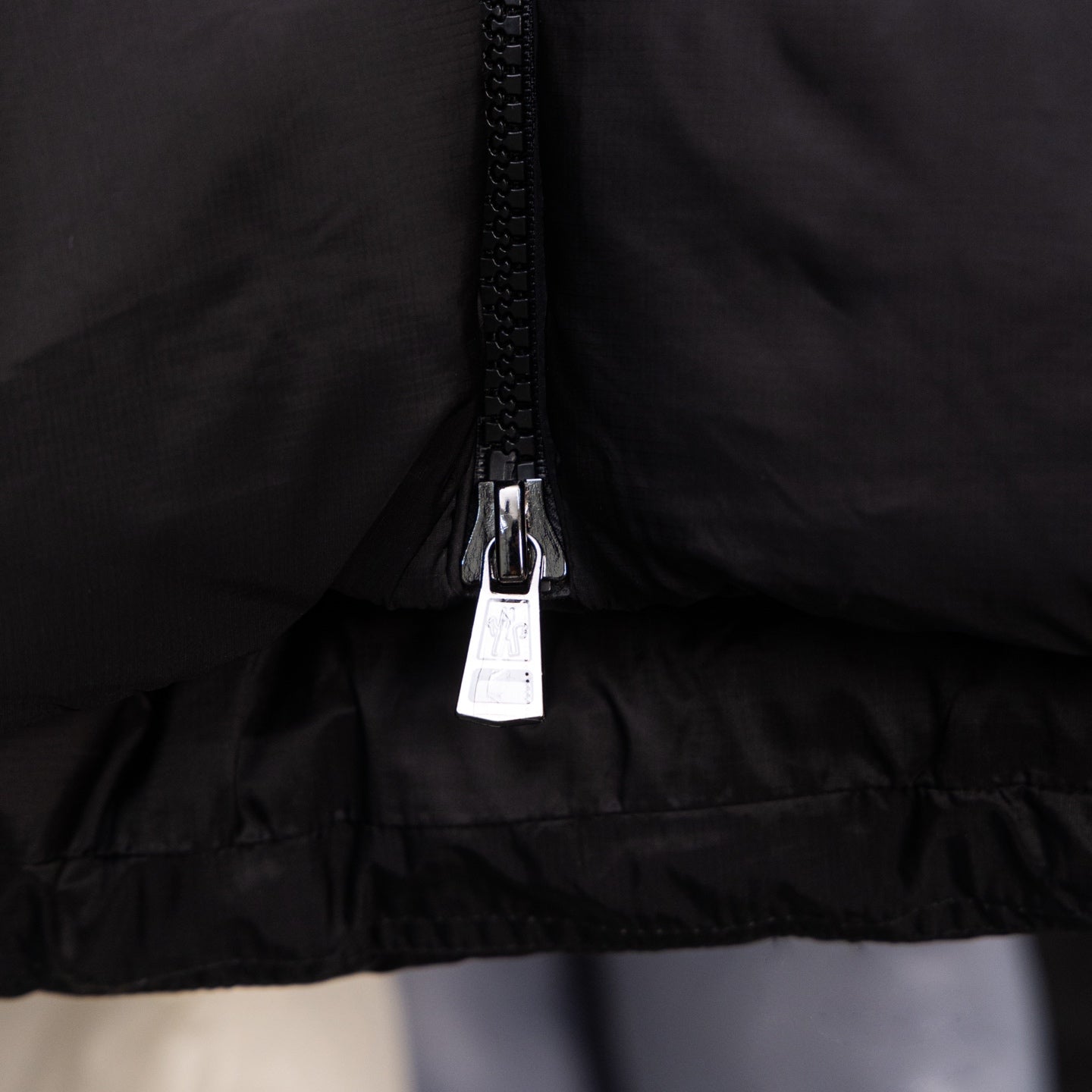 Long black puffer jacket, centered front zipper and hem
