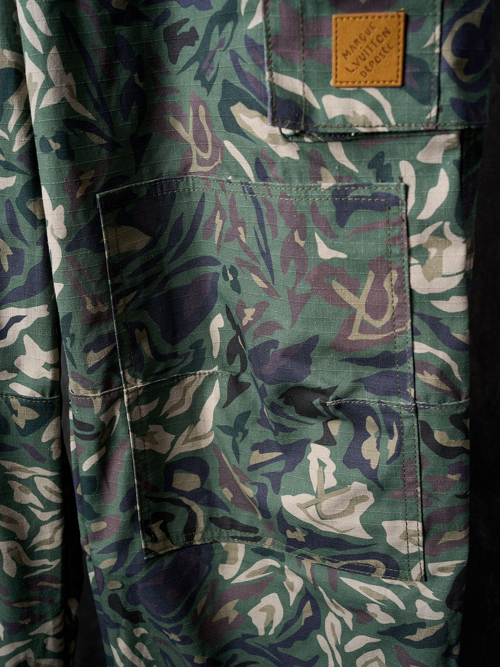 Louis Vuitton camouflage cargo pants close-up of front patch pocket and stitching