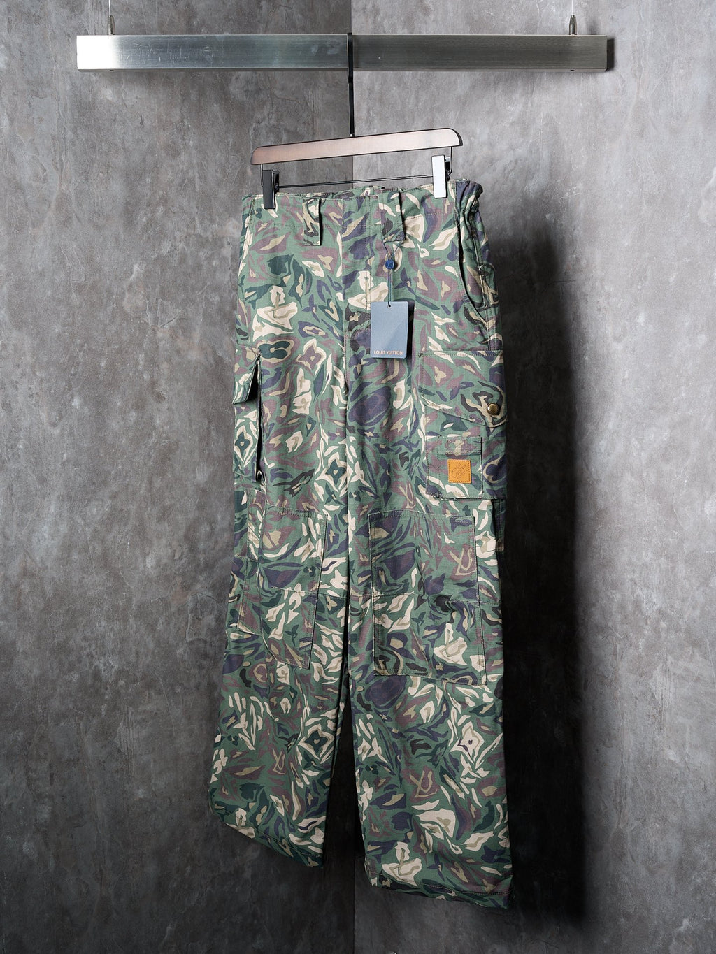 Louis Vuitton camouflage cargo pants on hanger with utility pockets and belt loops
