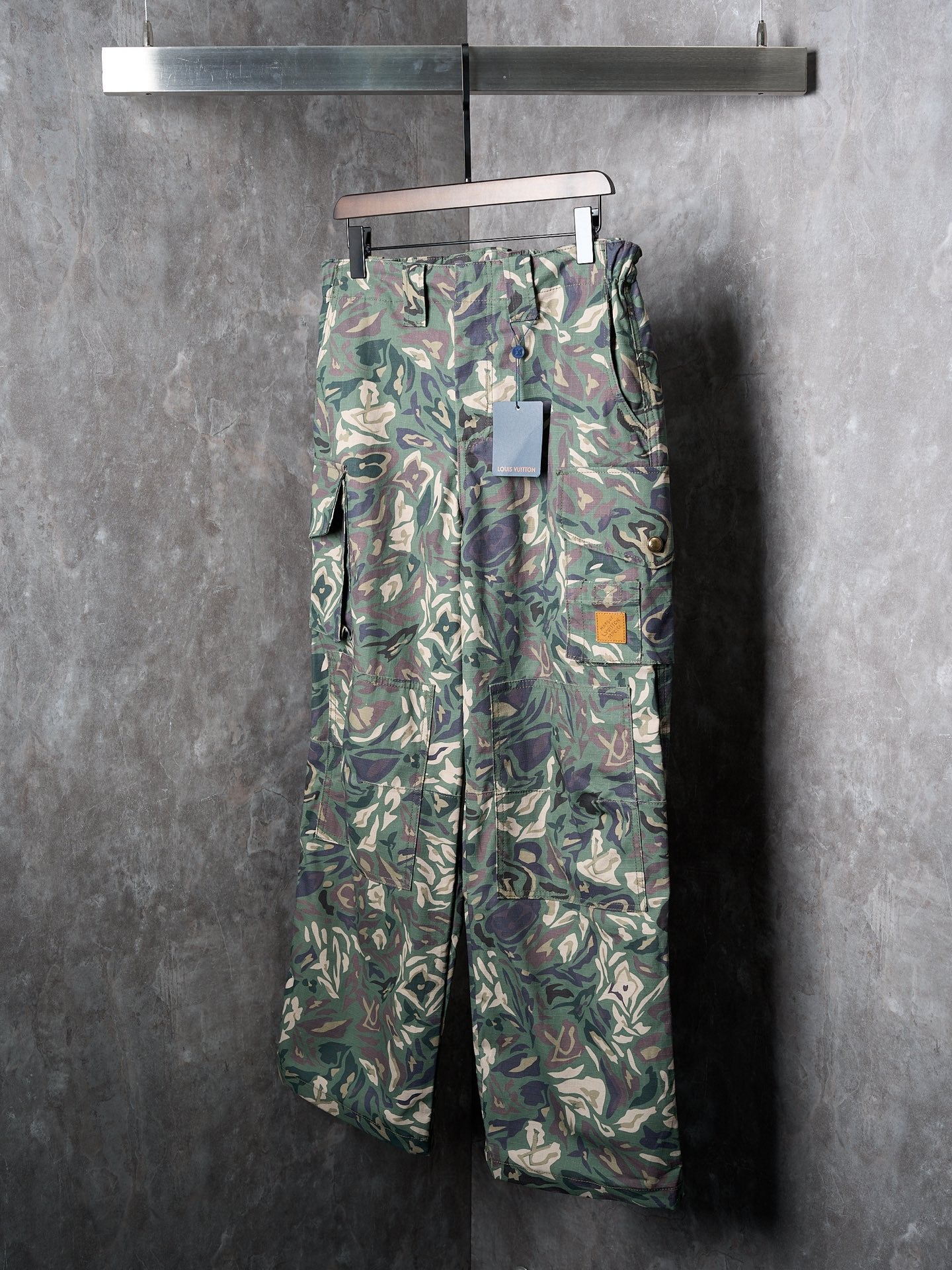 Louis Vuitton camouflage cargo pants on hanger with utility pockets and belt loops