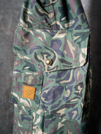 Louis Vuitton camouflage cargo pants side close-up of flap pocket and metal button