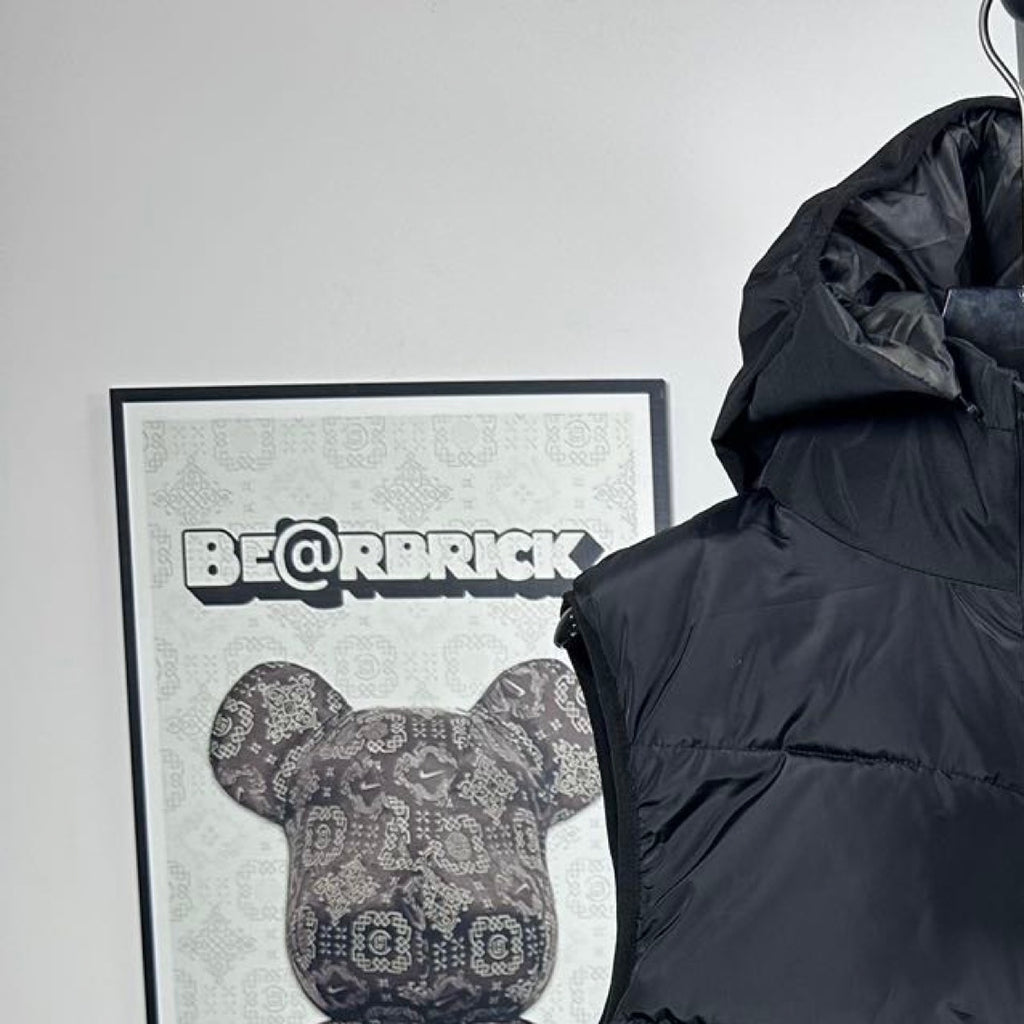 Moncler hood detail on dark puffer vest with front zip and quilted horizontal baffles