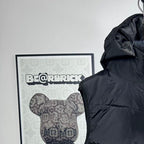 Moncler hood detail on dark puffer vest with front zip and quilted horizontal baffles
