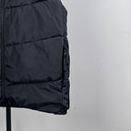 Moncler hooded puffer vest, close-up of dark quilted fabric and curved hem