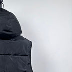 Moncler hooded puffer vest, upper side close-up with hood and dark quilted panel