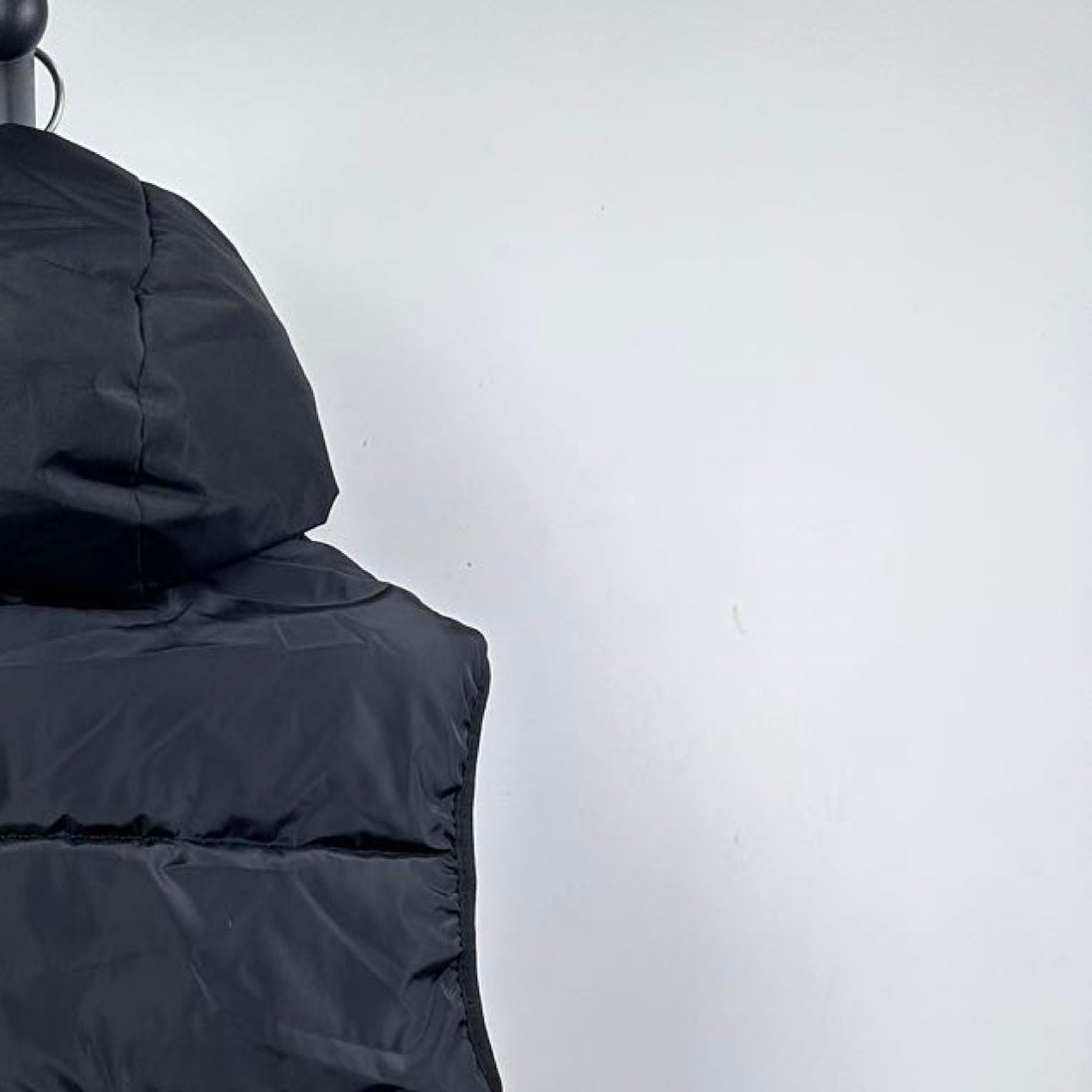 Moncler hooded puffer vest, upper side close-up with hood and dark quilted panel