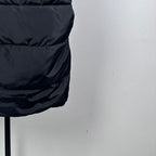 Dark black Moncler long puffer coat close-up with quilted horizontal stripes