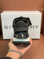 Luxury black sneakers heel close-up with strap closure and cushioned back collar