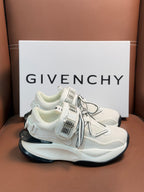 White sneakers with gray laces and chunky black-and-white sole