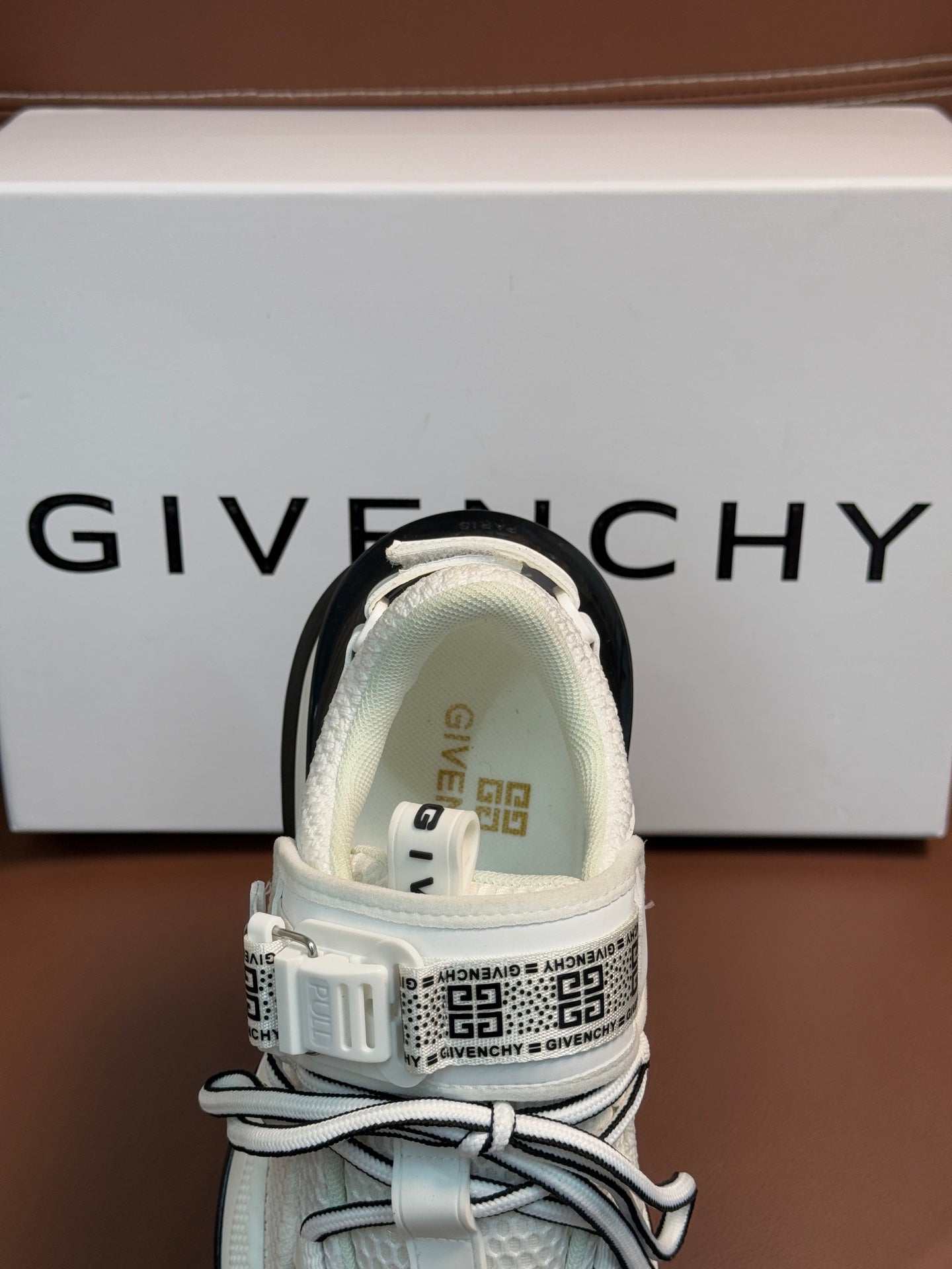 White sneakers back view with logo heel pull and chunky dark sole