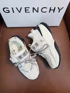 White sneakers, textured uppers, gray laces, chunky sole with dark accents