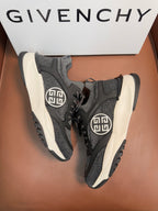 Dark gray lace-up sneakers, front angle, circular logo on side, white soles