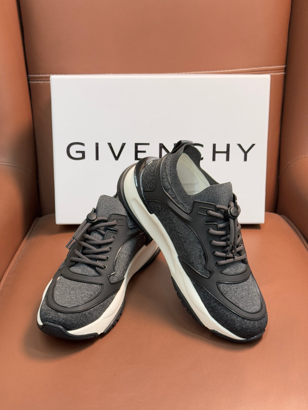 Dark gray lace-up sneakers with strap detail and white sole